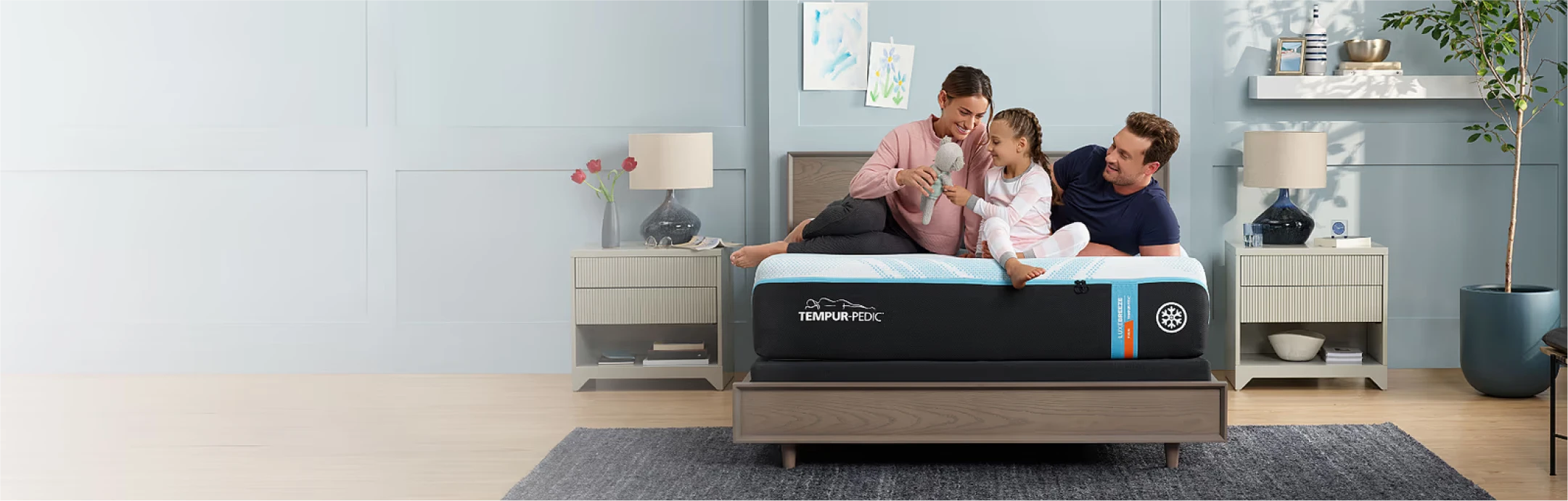 family laughing lying on tempur pedic mattress