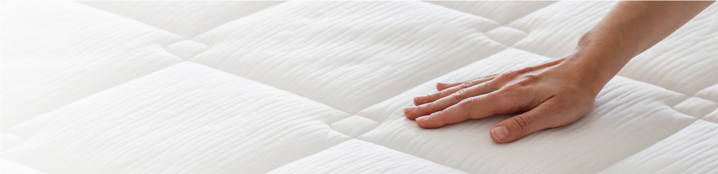 hand pushing on white mattress comfort soft